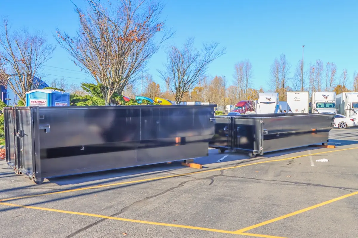 Professional dumpster rental service with roll-off container on residential driveway in Shenango
